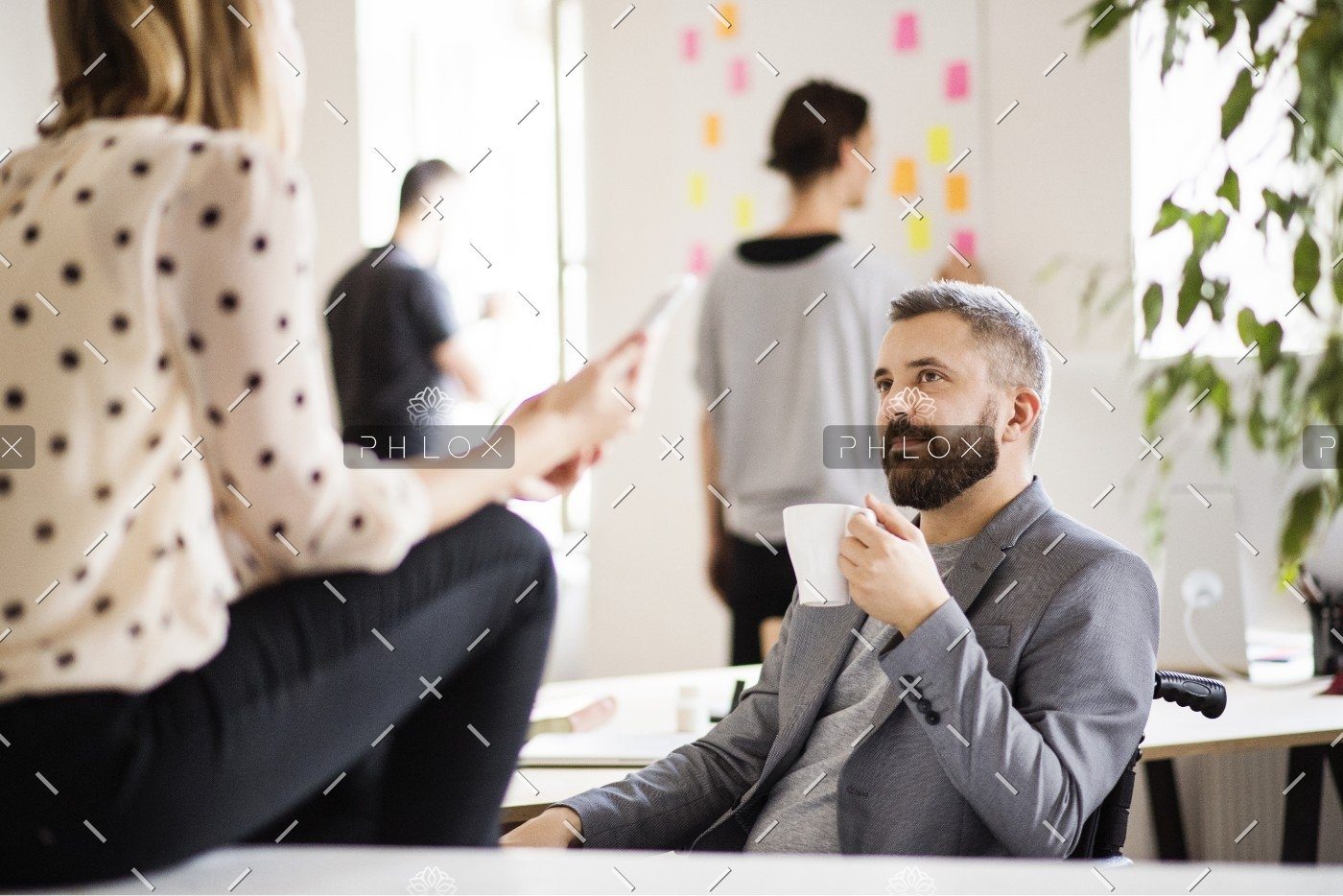 demo-attachment-647-business-people-with-wheelchair-in-the-office-P9M4RX3
